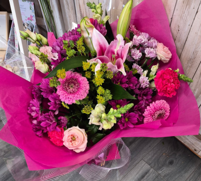 Berry Beautiful - A bold and beautiful bouquet bursting with rich pink and berry tones, softened with delicate pale pinks and fresh green accents.