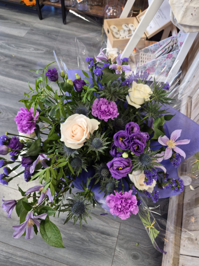Purple Serenity - A beautiful arrangement in rich purple and soft cream tones, perfect for any special occasion.