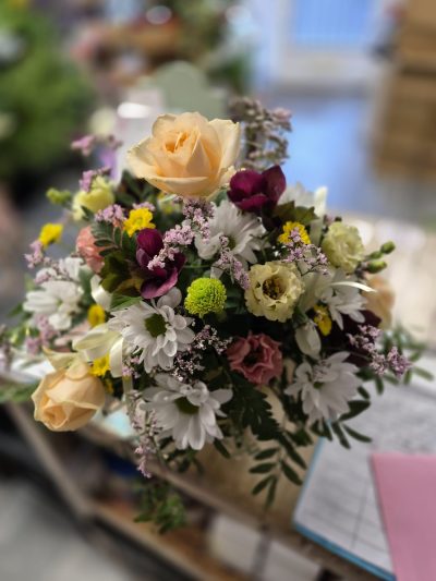 Country Charm - A delightful country-style arrangement filled with soft, cheerful colours.