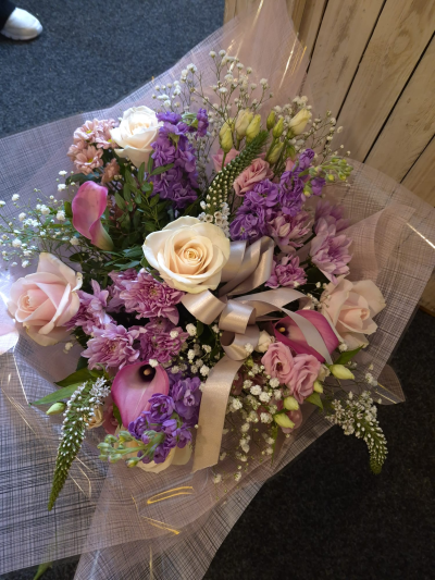 Lavender Blush - A romantic bouquet in soft pink, lilac and cream tones, finished with an elegant bow.