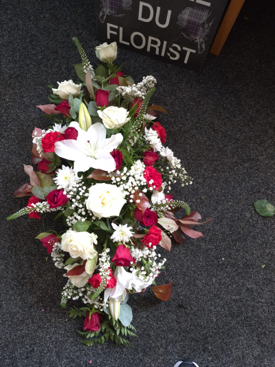 Crimson Farewell Spray - A striking funeral spray in red and white, expressing deep love and respect.