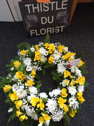 Golden Remembrance Wreath - A bright yet respectful wreath in yellow and white, celebrating warm and cherished memories.