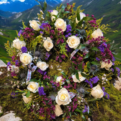 Highland Remembrance Wreath - A natural wreath in white and purple shades, beautifully finished with tartan ribbon.