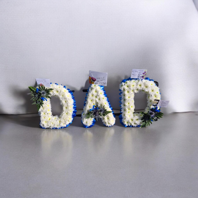 Ribbon Letters - A classic white letter tribute with blue edging, created in memory of loved one.