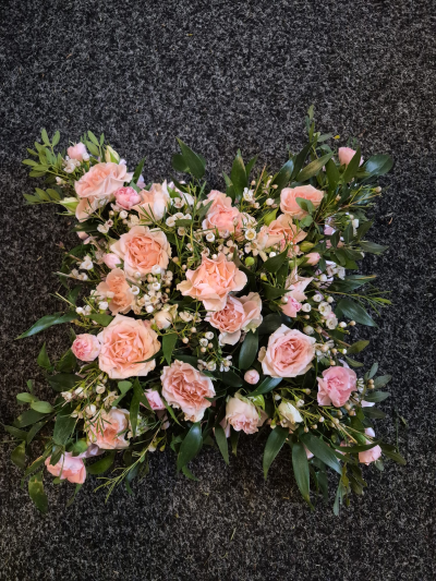 Rose Cushion - A delicate wreath in soft blush pink tones, expressing love and remembrance.