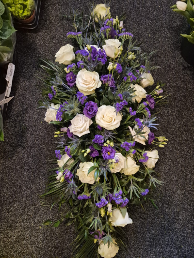 Purple Serenity Spray - An elegant funeral spray in white and purple, arranged with care and sensitivity.