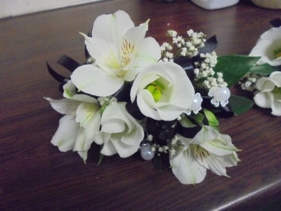 Corsage - A corsage to colour co-ordinate.
Wrist bag or jacket to choose from. 
Fresh or Artificial